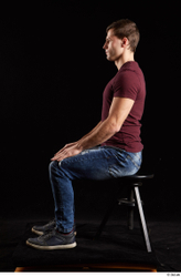 Tomas Salek  blue jeans dressed grey shoes red t shirt sitting whole body  jpg
